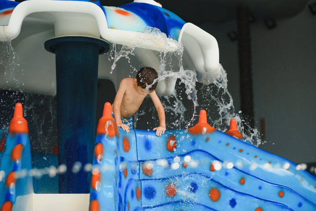boy is in the water park.