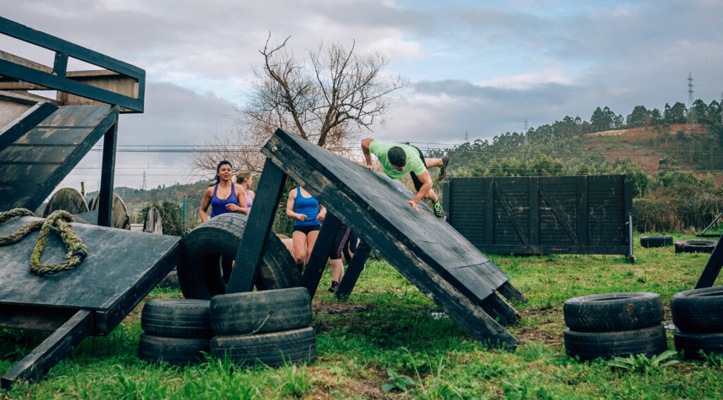 participants in obstacle course climbing wall
